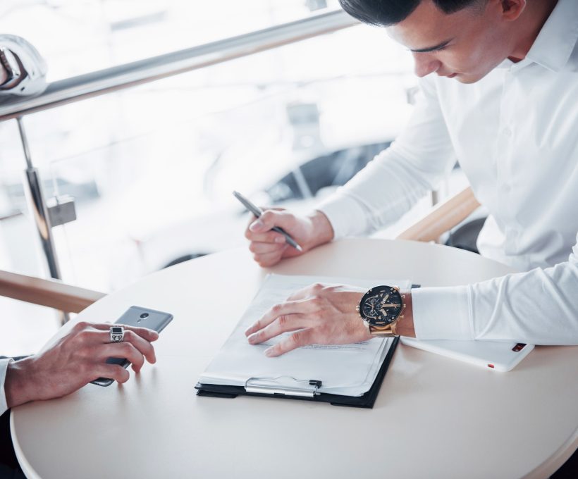 young-man-signs-documents-in-the-office-successful-sales.jpg